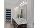 Well-lit bathroom with double sink vanity, large mirror, and separate room with shower and toilet at 6171 Willow Farm Dr, Denver, NC 28037