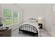 A bright bedroom with a metal-frame bed and ample natural light from the large window at 6171 Willow Farm Dr, Denver, NC 28037