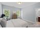 Well-lit bedroom features neutral walls, plush carpeting, and windows with views of the surrounding landscape at 6171 Willow Farm Dr, Denver, NC 28037