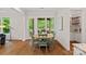 Cozy breakfast nook featuring hardwood floors, a round table, and views of the outdoor area with a grill at 6171 Willow Farm Dr, Denver, NC 28037