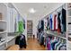 Spacious walk-in closet features custom shelving, wood flooring, and ample storage for clothes and shoes at 6171 Willow Farm Dr, Denver, NC 28037