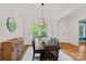 Charming dining room featuring wood floors, a rustic table, and a modern light fixture at 6171 Willow Farm Dr, Denver, NC 28037