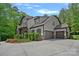 Beautiful two-story home featuring neutral siding, stone accents, and a three-car garage with an extended driveway at 6171 Willow Farm Dr, Denver, NC 28037