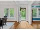 Inviting foyer with hardwood floors, an open door leading to the front yard, and a view of the dining area at 6171 Willow Farm Dr, Denver, NC 28037