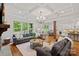 Open-concept living room showcases hardwood floors, a fireplace, and seamless flow into the kitchen and breakfast area at 6171 Willow Farm Dr, Denver, NC 28037