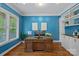 A well-lit home office with custom built-ins and an expansive wooden desk at 6171 Willow Farm Dr, Denver, NC 28037