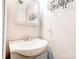 Simple bathroom with modern light fixture, mirror, and a small sink at 619 E Sanders Rd, Shelby, NC 28150