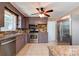 Kitchen features a stainless-steel refrigerator, gas oven, microwave, and updated cabinets at 619 E Sanders Rd, Shelby, NC 28150