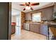 Functional kitchen features tile flooring, updated appliances, and neutral-colored cabinets at 619 E Sanders Rd, Shelby, NC 28150