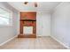 Spacious living area featuring tile floors, a decorative brick fireplace and a window at 619 E Sanders Rd, Shelby, NC 28150
