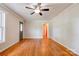 A spacious living room with hardwood floors, a ceiling fan and large window at 619 E Sanders Rd, Shelby, NC 28150
