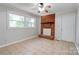 Spacious living area featuring tile floors, a decorative brick fireplace and a window at 619 E Sanders Rd, Shelby, NC 28150
