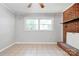 Spacious living area featuring tile floors, a decorative brick fireplace and a window at 619 E Sanders Rd, Shelby, NC 28150