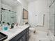 Bathroom featuring a modern vanity, neutral walls, and tiled shower at 6309 Wakehurst Rd, Charlotte, NC 28226