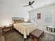 Cozy bedroom with neutral colored walls, ceiling fan, and carpeted floor at 6309 Wakehurst Rd, Charlotte, NC 28226