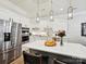 Beautiful white kitchen with a large island, stainless steel appliances, and elegant pendant lighting at 6309 Wakehurst Rd, Charlotte, NC 28226