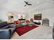 Large living room with ample seating, neutral walls, and a decorative rug at 6309 Wakehurst Rd, Charlotte, NC 28226