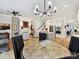 Open-concept living room and dining area with modern lighting, fireplace, and hardwood floors at 6309 Wakehurst Rd, Charlotte, NC 28226