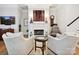 Cozy living room with fireplace, comfortable seating, and hardwood floors at 6309 Wakehurst Rd, Charlotte, NC 28226