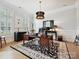 Bright office space with large desk, plantation shutters, statement lighting, and light hardwood floors at 6309 Wakehurst Rd, Charlotte, NC 28226