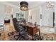 Well-appointed office showcasing a large desk, hardwood floors and sophisticated decorative elements at 6309 Wakehurst Rd, Charlotte, NC 28226