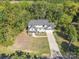 Aerial view of a charming home with long driveway and lush green surroundings at 685 Knollcrest Ne Dr, Concord, NC 28025