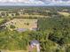Overhead view of a luxury home surrounded by forest, pond, and farmland at 685 Knollcrest Ne Dr, Concord, NC 28025