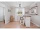 Cozy bar area with wooden bar stools, a white-washed bar, and a window providing natural light at 685 Knollcrest Ne Dr, Concord, NC 28025