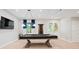 Finished basement with covered pool table, french doors, and recessed lighting at 685 Knollcrest Ne Dr, Concord, NC 28025
