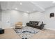 Finished basement with gray movie seating, patterned rug, light wood flooring, and recessed lighting at 685 Knollcrest Ne Dr, Concord, NC 28025