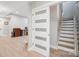 Basement landing with stairway, white door, and desk area at 685 Knollcrest Ne Dr, Concord, NC 28025