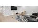 Finished basement with gray seating, patterned rug, light wood flooring, and large screen tv at 685 Knollcrest Ne Dr, Concord, NC 28025