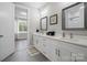 Bright bathroom featuring double sinks, white cabinets, and modern fixtures at 685 Knollcrest Ne Dr, Concord, NC 28025