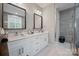 Sleek bathroom featuring double sinks, white cabinets, and a modern walk-in shower at 685 Knollcrest Ne Dr, Concord, NC 28025
