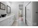 Bathroom with a walk-in shower, white cabinets, sink, and modern fixtures at 685 Knollcrest Ne Dr, Concord, NC 28025