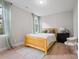 Simple bedroom with a wood bed frame, minimal decor, and natural light through windows at 685 Knollcrest Ne Dr, Concord, NC 28025