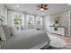 Bright bedroom featuring white trim, hardwood floors, a bed with decorative pillows, and natural light at 685 Knollcrest Ne Dr, Concord, NC 28025