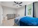 This bedroom features a ceiling fan, light-colored hardwood floors, and neutral-colored walls at 685 Knollcrest Ne Dr, Concord, NC 28025