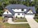 Aerial view of a two-story home with a well-maintained lawn and inviting front porch at 685 Knollcrest Ne Dr, Concord, NC 28025