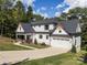 Beautiful modern farmhouse with white siding, a dark roof, and a well-manicured lawn at 685 Knollcrest Ne Dr, Concord, NC 28025