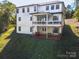 Exterior angle view of a white two-story home with a spacious backyard at 685 Knollcrest Ne Dr, Concord, NC 28025