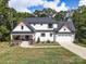 Beautiful two-story house with well-kept lawn, landscaping, and inviting front porch at 685 Knollcrest Ne Dr, Concord, NC 28025