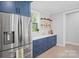Updated kitchen featuring stainless steel refrigerator, blue cabinets, and a bright, airy atmosphere at 685 Knollcrest Ne Dr, Concord, NC 28025