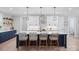 Beautiful kitchen island with bar stool seating, modern pendant lights, and sleek white cabinets at 685 Knollcrest Ne Dr, Concord, NC 28025