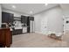 Basement kitchenette featuring dark cabinets, farm sink, and modern appliances at 685 Knollcrest Ne Dr, Concord, NC 28025