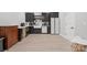 Basement kitchenette featuring dark cabinets, farm sink, and modern appliances at 685 Knollcrest Ne Dr, Concord, NC 28025