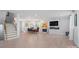 Open-concept living room with dining area, fireplace with fish tank, and staircase at 685 Knollcrest Ne Dr, Concord, NC 28025