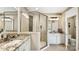 Well-lit bathroom showcasing granite countertops, dual sinks, and glass-enclosed shower at 7324 Jolly Brook Dr, Charlotte, NC 28215