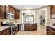 Modern kitchen featuring stainless steel appliances, granite countertops, and wooden cabinetry at 7324 Jolly Brook Dr, Charlotte, NC 28215