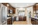 Modern kitchen featuring stainless steel appliances, granite countertops, and wooden cabinetry at 7324 Jolly Brook Dr, Charlotte, NC 28215